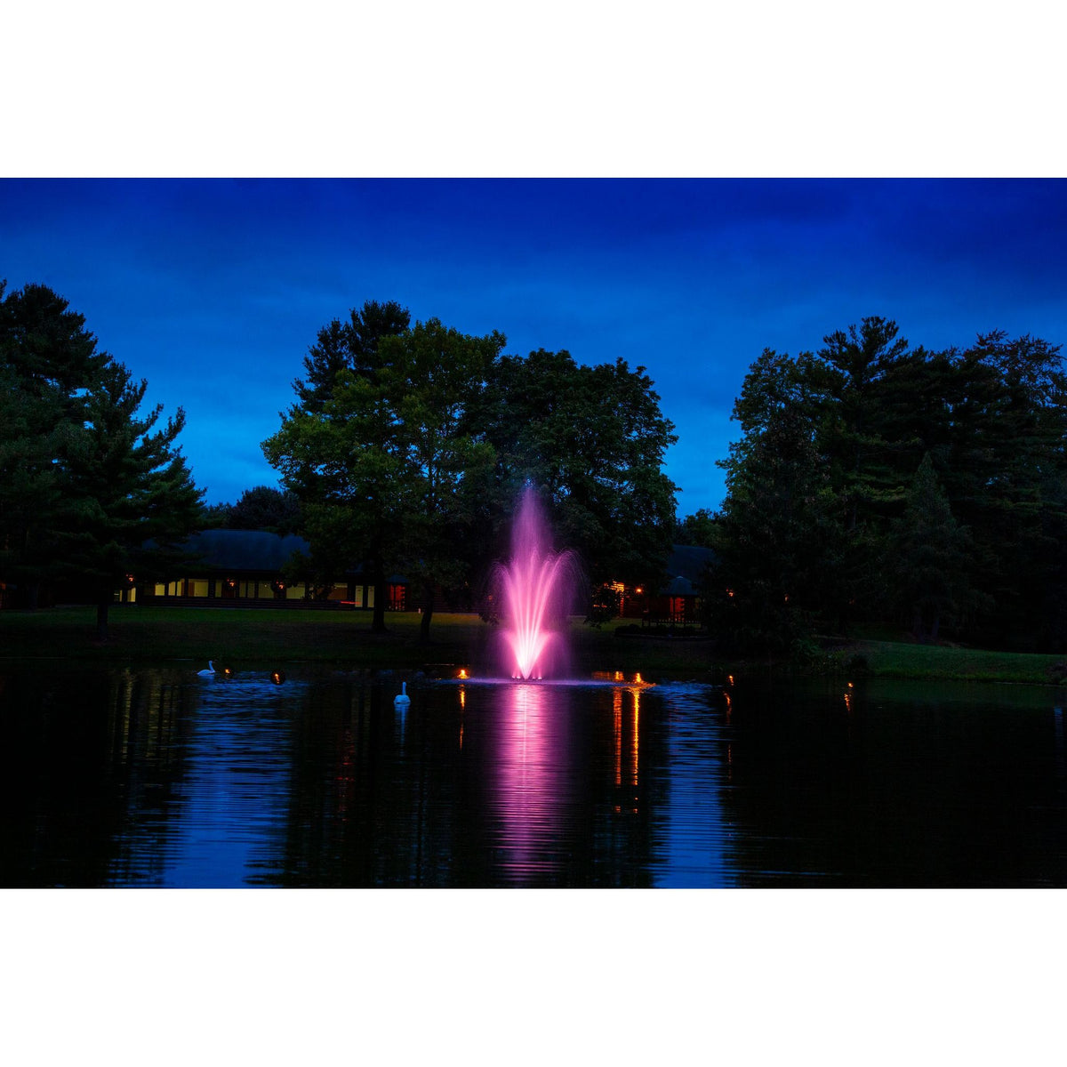 Scott Aerator Amherst Fountain In A Large Lake With Beautiful Pink Lights