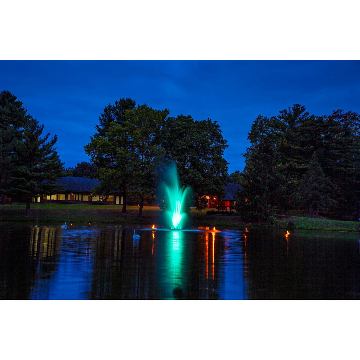 Scott Aerator Amherst Pond Fountain Pictured At Night With Green Glowing Lights